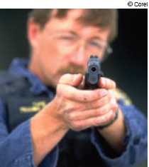 Photograph of police officer aiming a handgun